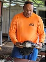 John Kiapo demonstrates fishing protocol around sea turtles