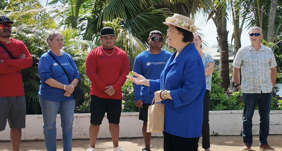 Mazie Hirono standing with members of the Daughters of the American Revolution and local community members during an outdoor visit at Kanewai Springs, engaging in conversation about the site and community concerns.